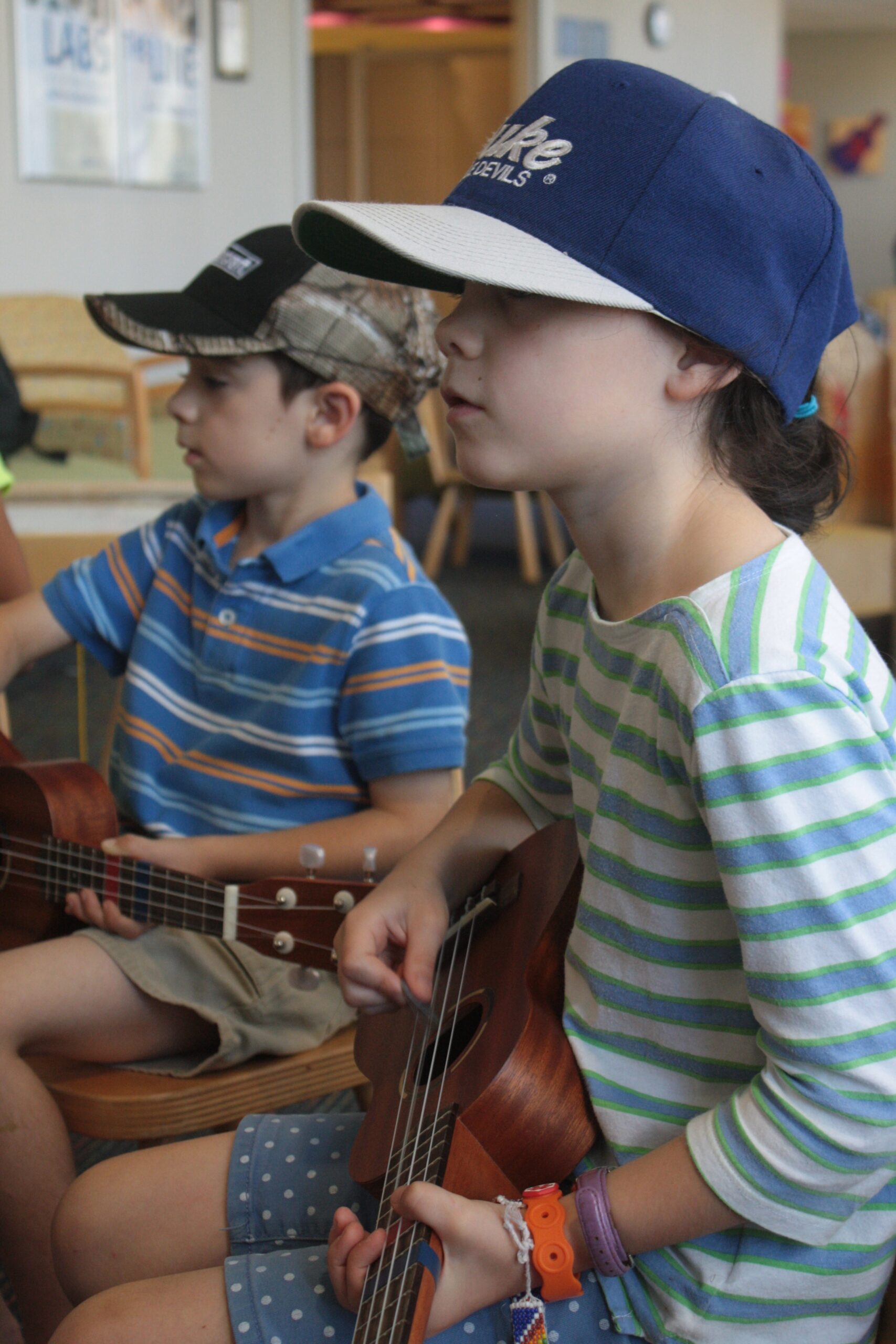 Two children playing guitar